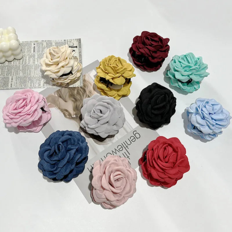 Assorted fabric rose hair claw clips in multiple colors with barrette clips