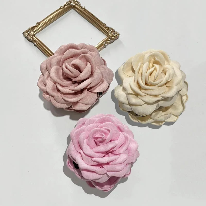 3-pack fabric rose hair claw clips in pink, pale pink, and cream with claw bars