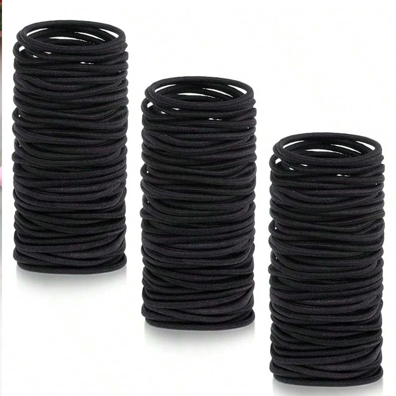 Black hair ties, rolled stack of small ponytail elastic bands