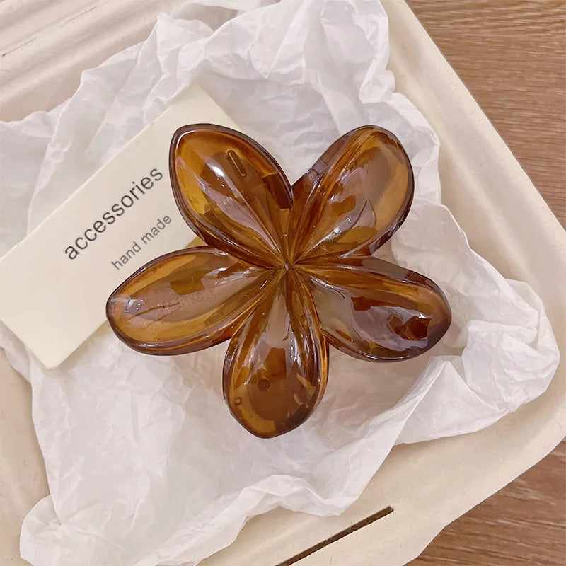 Hawaiian gradient flower hair claw clip with amber-brown translucent petals