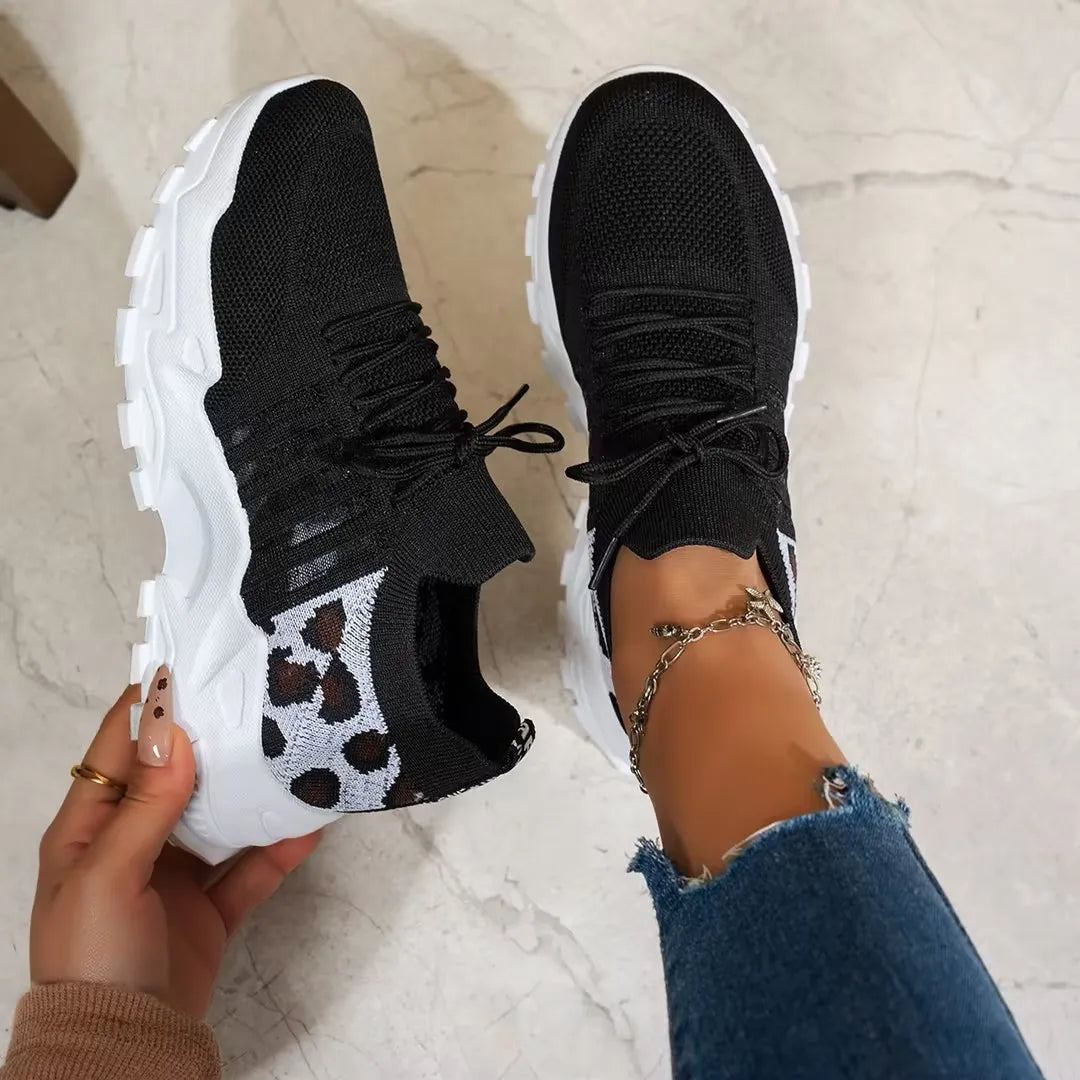 Women's leopard print athletic sneakers, pair, breathable black knit upper with thick white sole