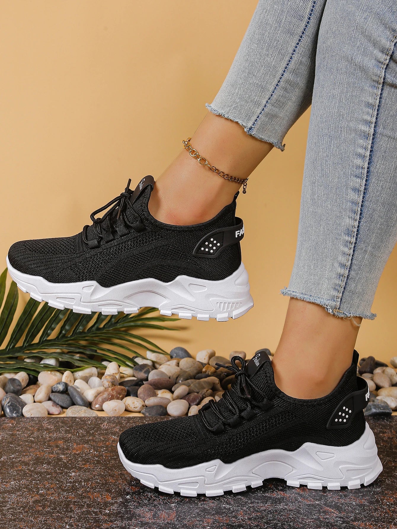 Women's black breathable mesh athletic sneakers with thick white sole, 2 sneakers shown