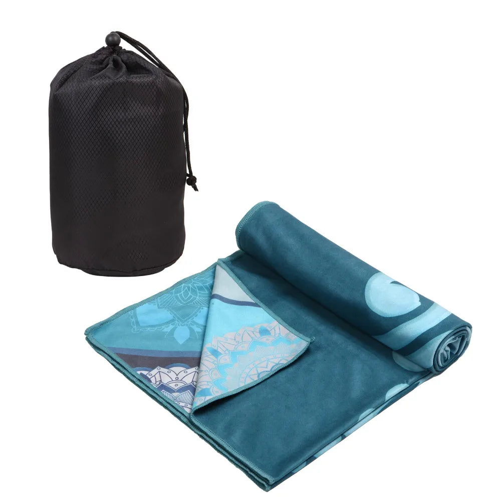 Teal blue yoga mat towel folded with patterned side and carry bag