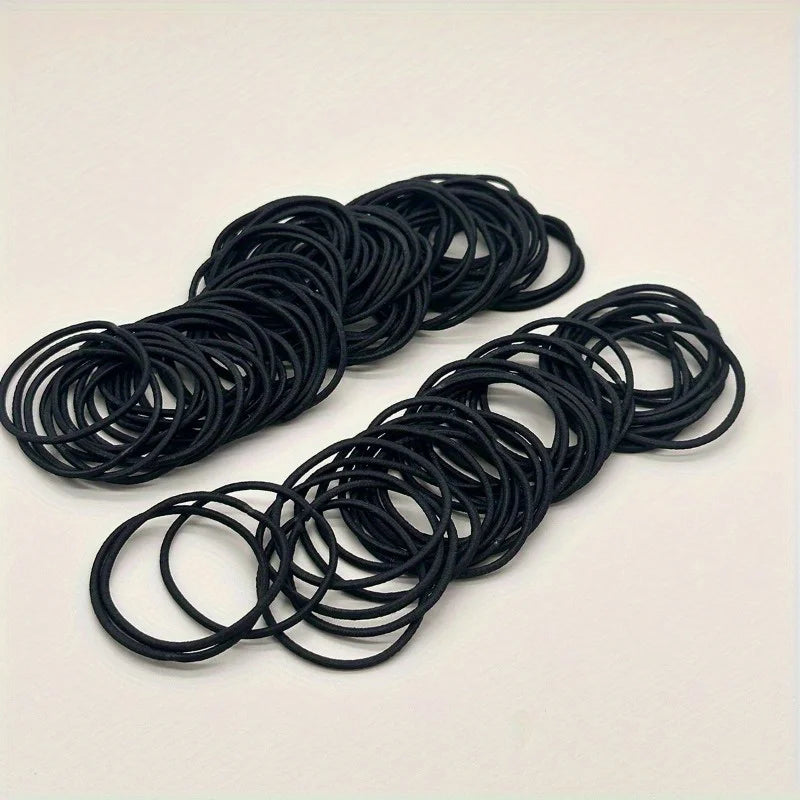 Black hair ties, tangled loops of ponytail elastic bands