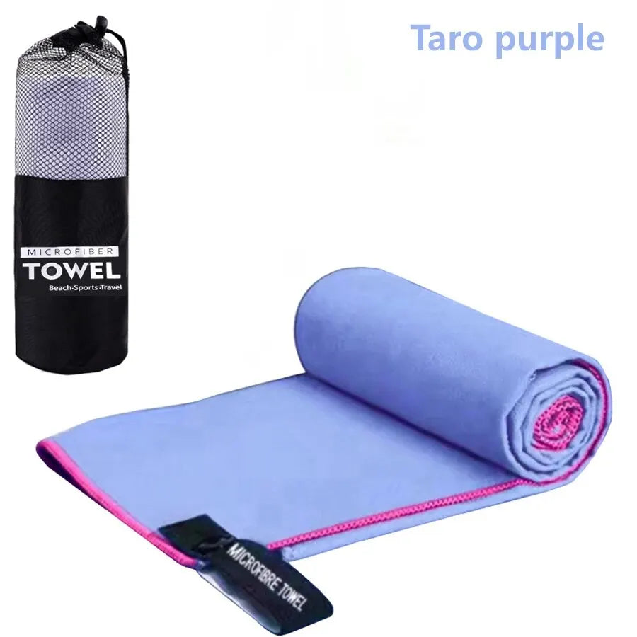 Cedar & Moore quick-dry microfiber sports towel, purple with pink edge, shown with black mesh storage bag