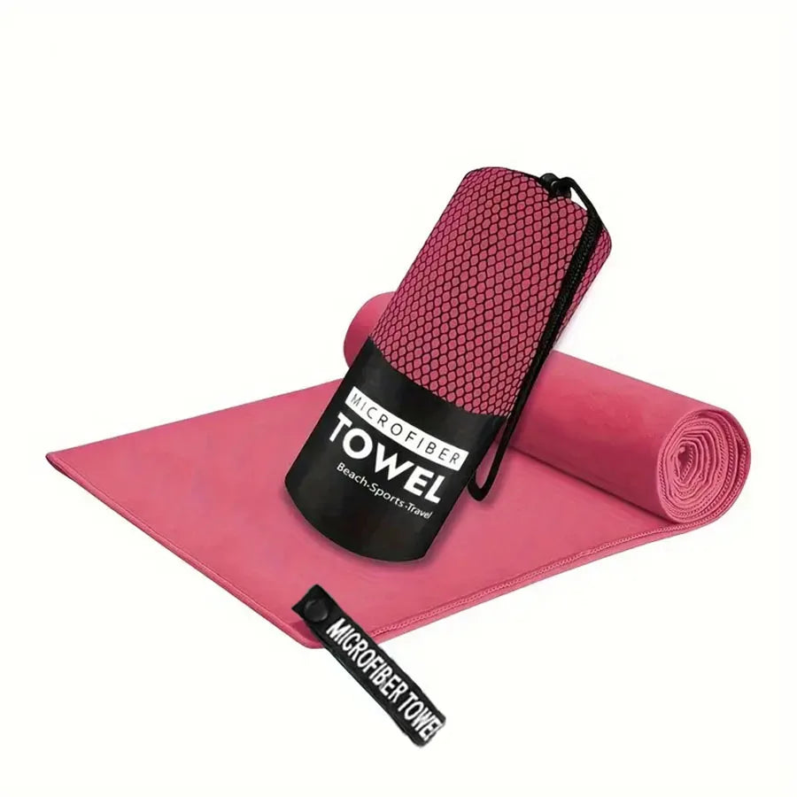 Microfiber yoga gym towel in rose pink, folded with rolled matching towel