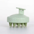 Green silicone scalp massage shampoo brush with flexible bristles and handle loop