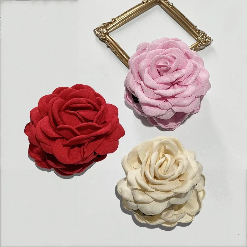 3-pack fabric rose hair claw clips in red, pink, and cream with claw bars