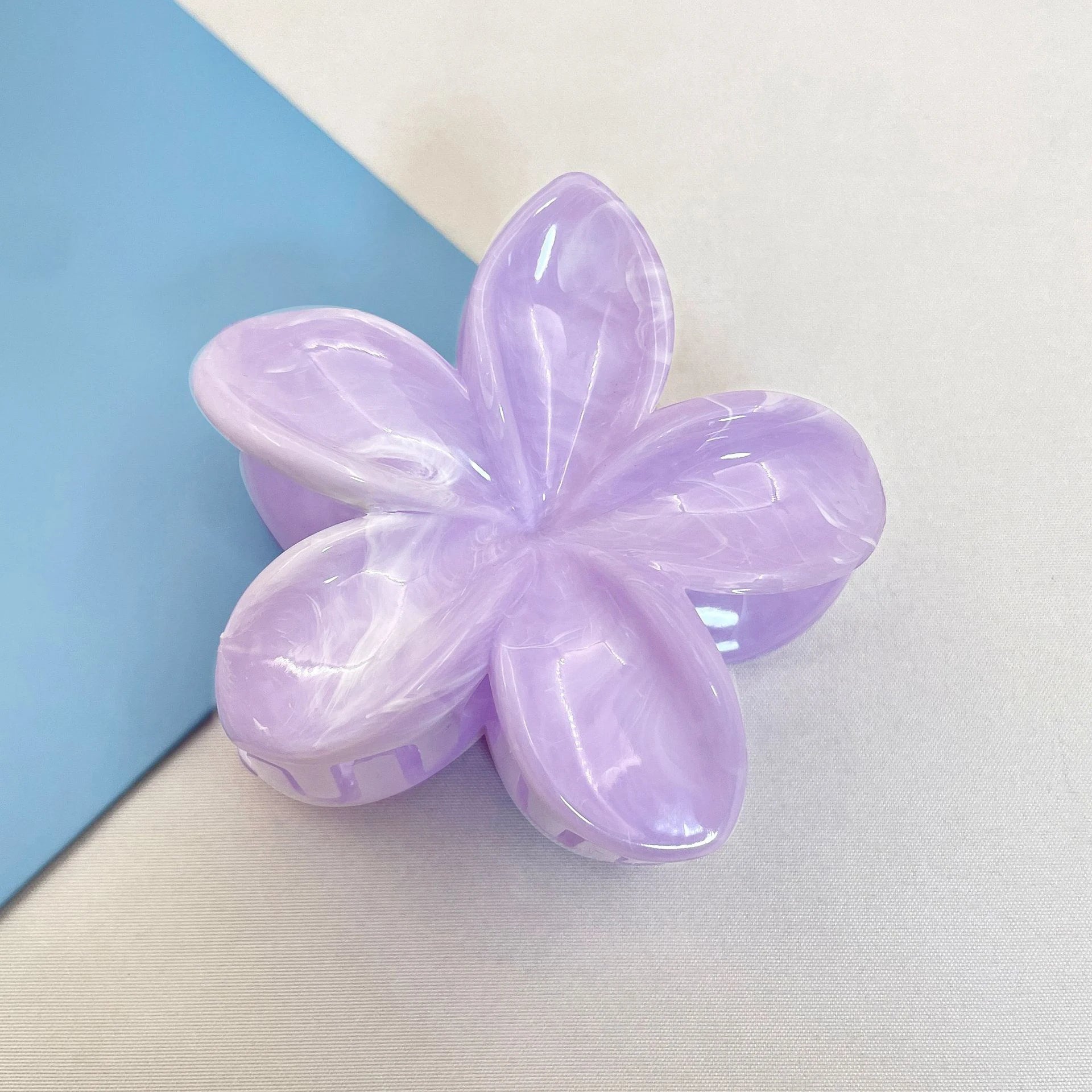 Lavender flower hair claw clip with translucent five-petal design and plastic barrette