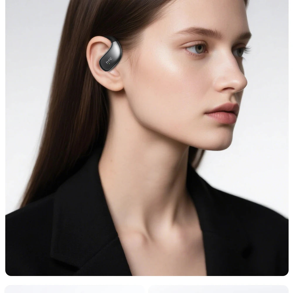 Black sports earbuds in-ear on a model, left ear visible