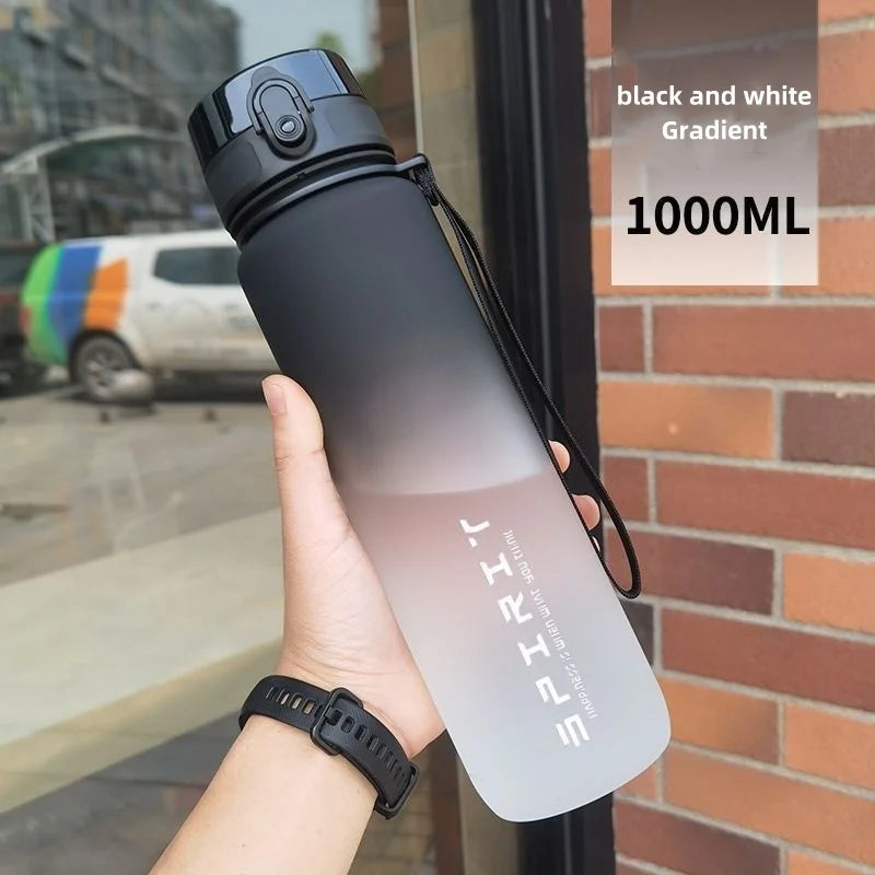 Sports water bottle with straw, matte black and white gradient, flip-top lid, carry loop