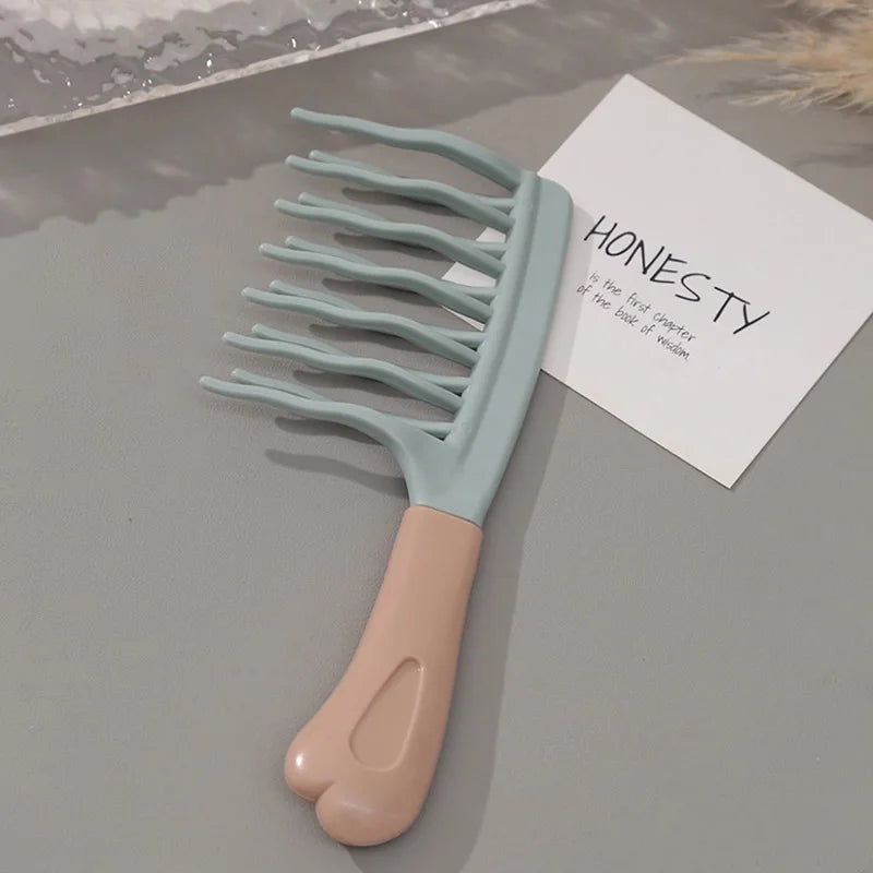 Light blue wide-tooth detangling comb with long prongs and beige handle, on card
