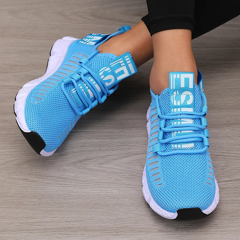 Women’s lightweight running shoes, light blue knit upper with strap closure and white sole