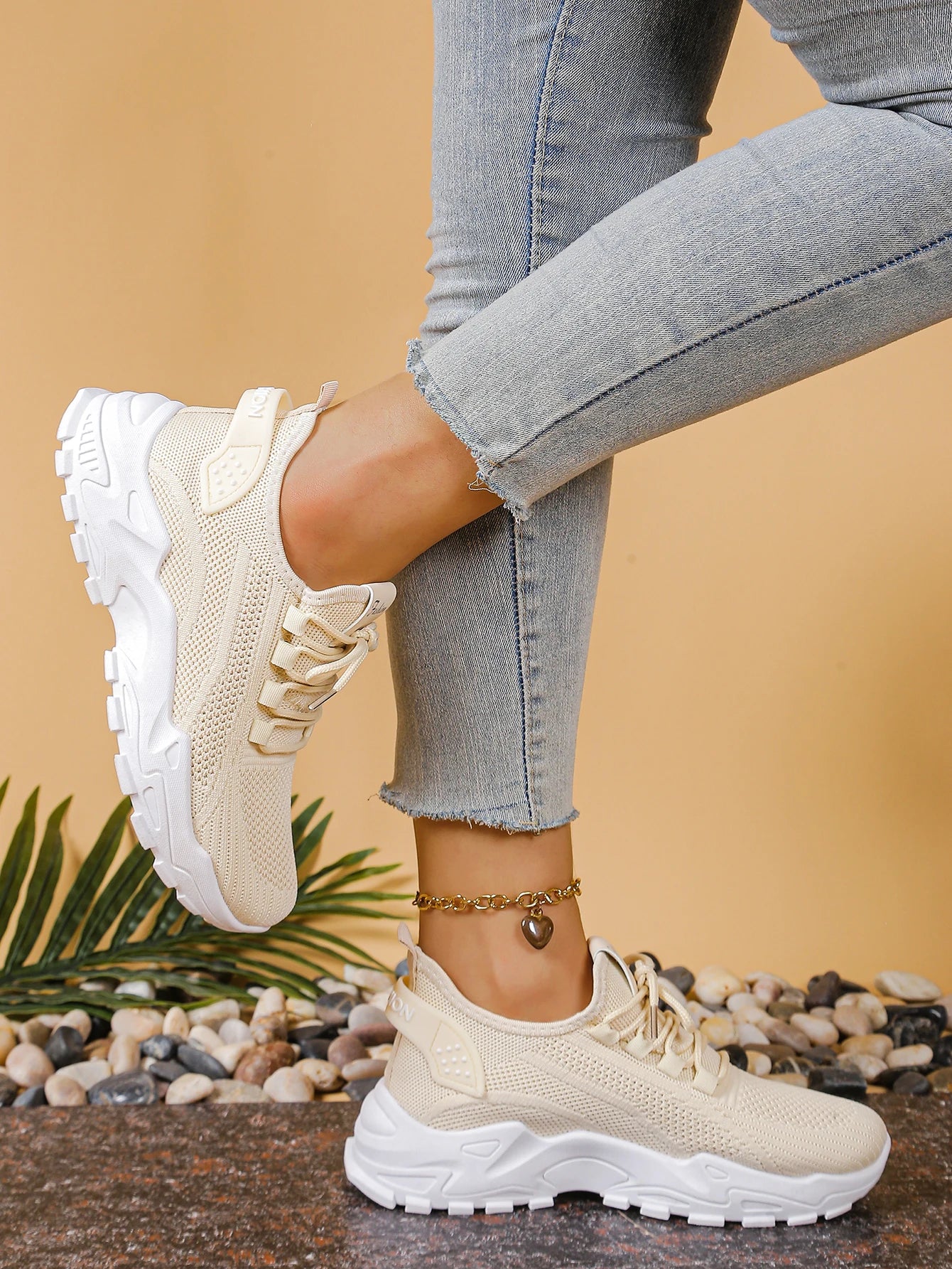Pair of women's Cedar & Moore breathable mesh athletic sneakers with thick white sole in cream beige.