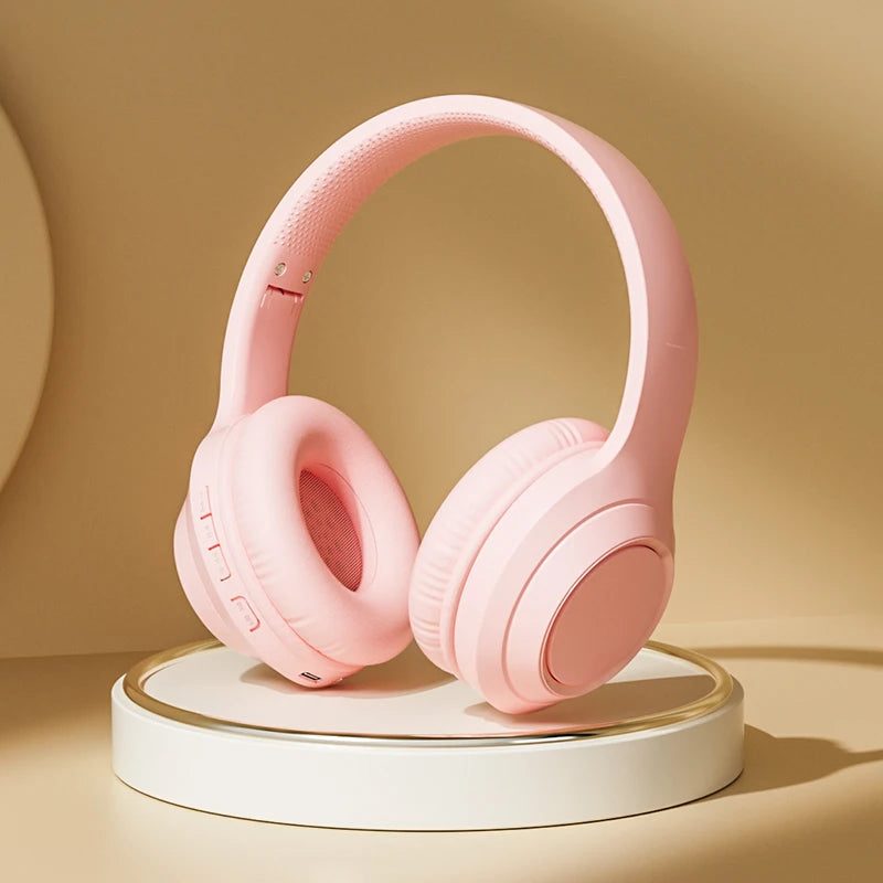 Pink over-ear wireless headphones with padded ear cups and cushioned headband