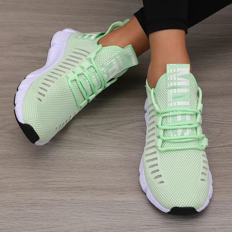 Lightweight running shoes in light green with white soles and lace-up straps