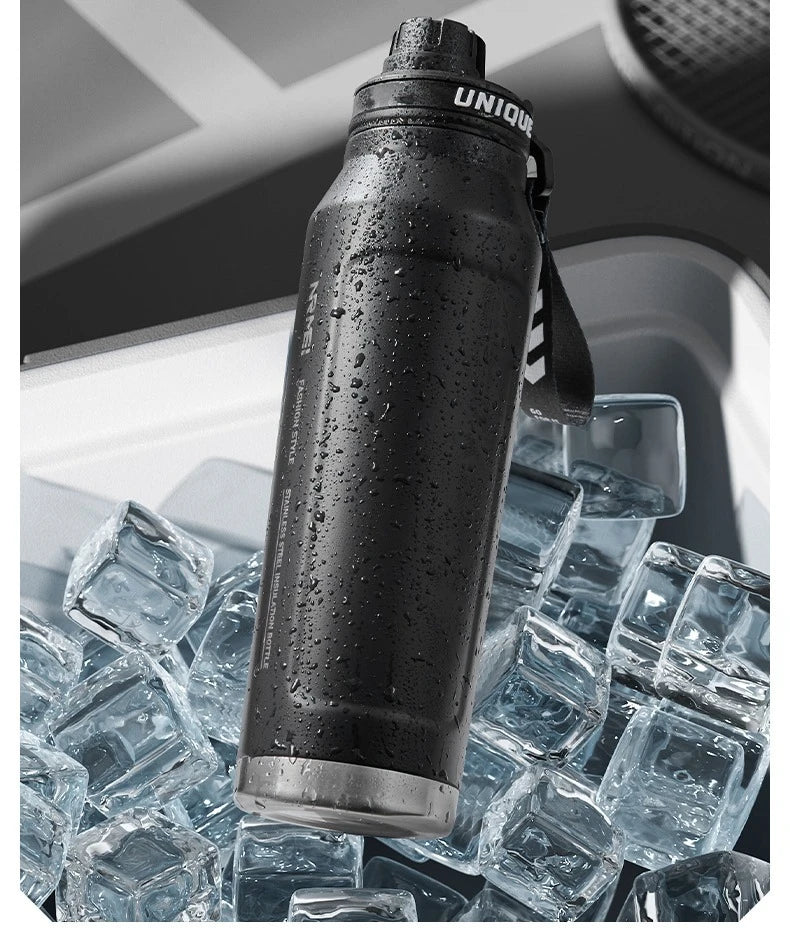 Insulated stainless steel sports bottle with water droplets over ice