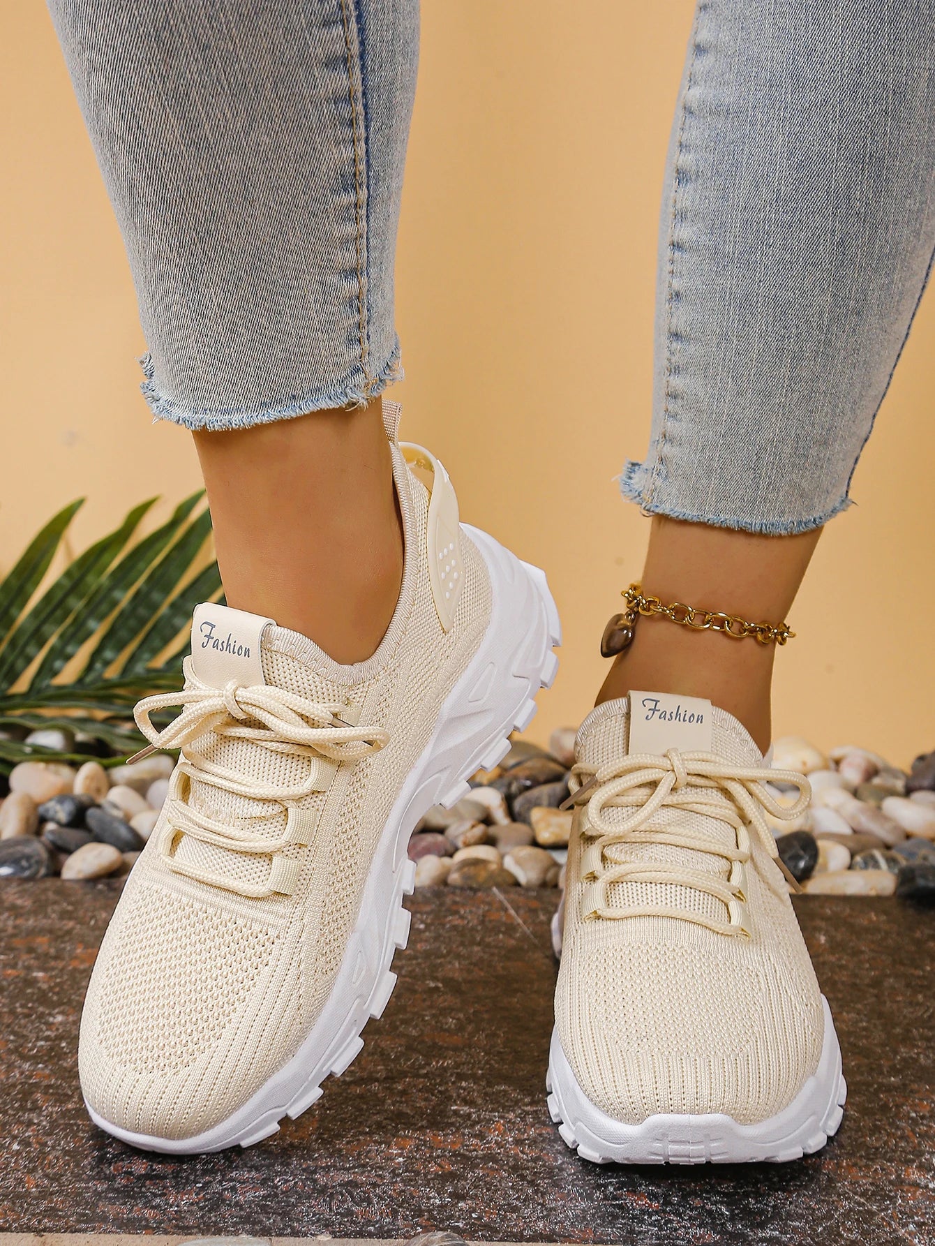 Women's beige breathable mesh athletic sneakers with thick white soles, pair