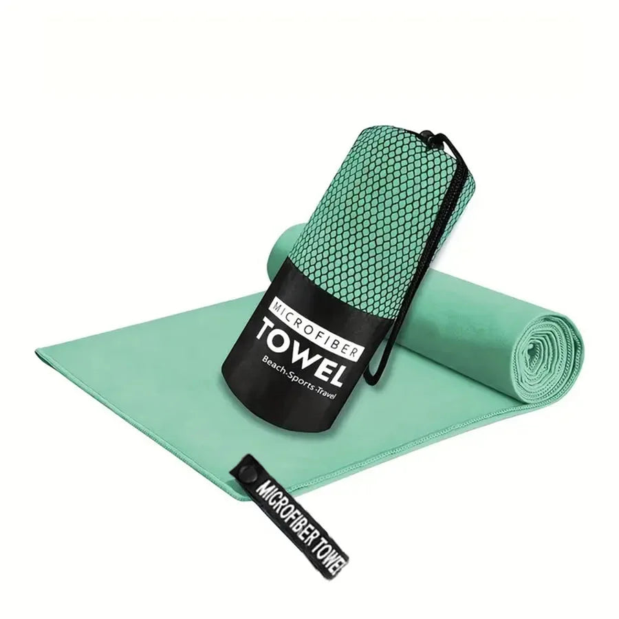 Microfiber yoga gym towel in mint green, folded with rolled matching towel