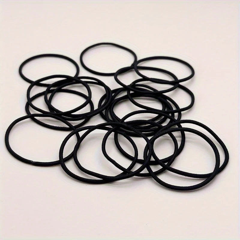 Black hair ties, scattered round elastic loops
