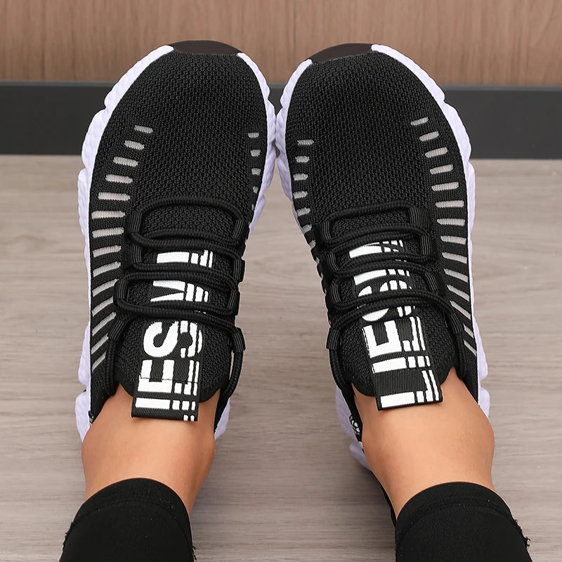 Lightweight running shoes in black with white soles and lace-up straps