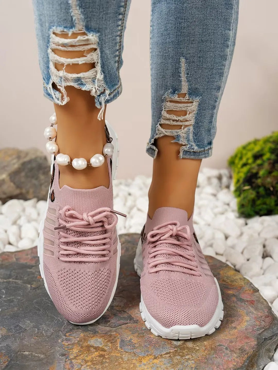 Women’s pink knit athletic sneakers with breathable upper and thick white sole for workouts