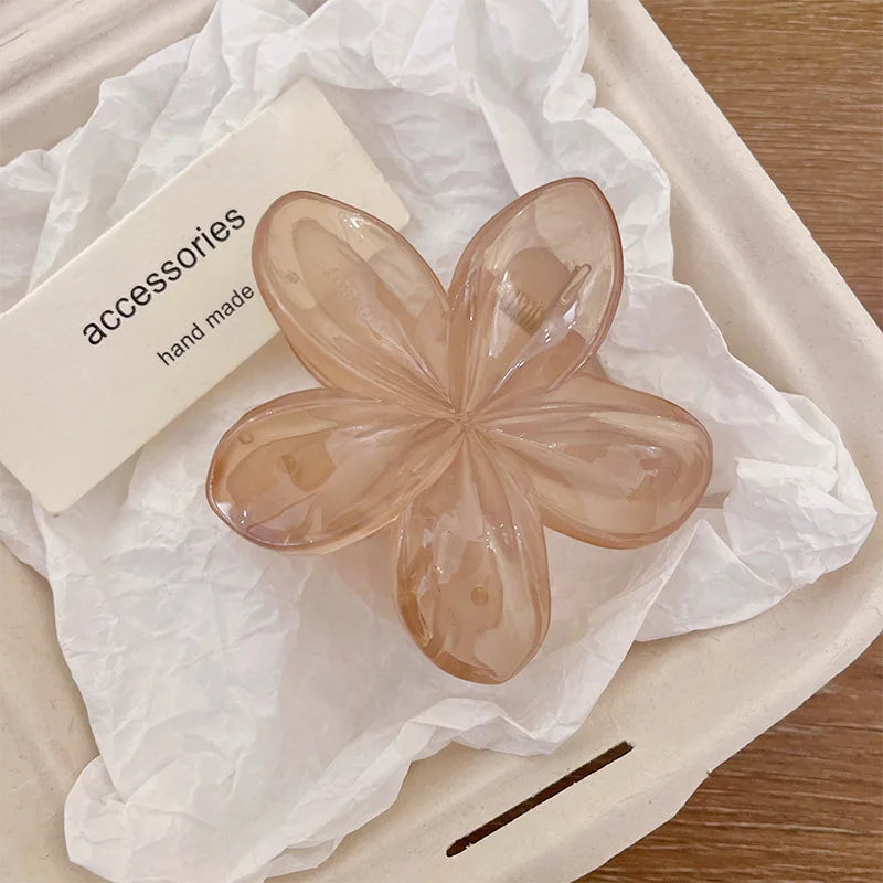 Beige flower hair claw clip with translucent five-petal design and plastic barrette