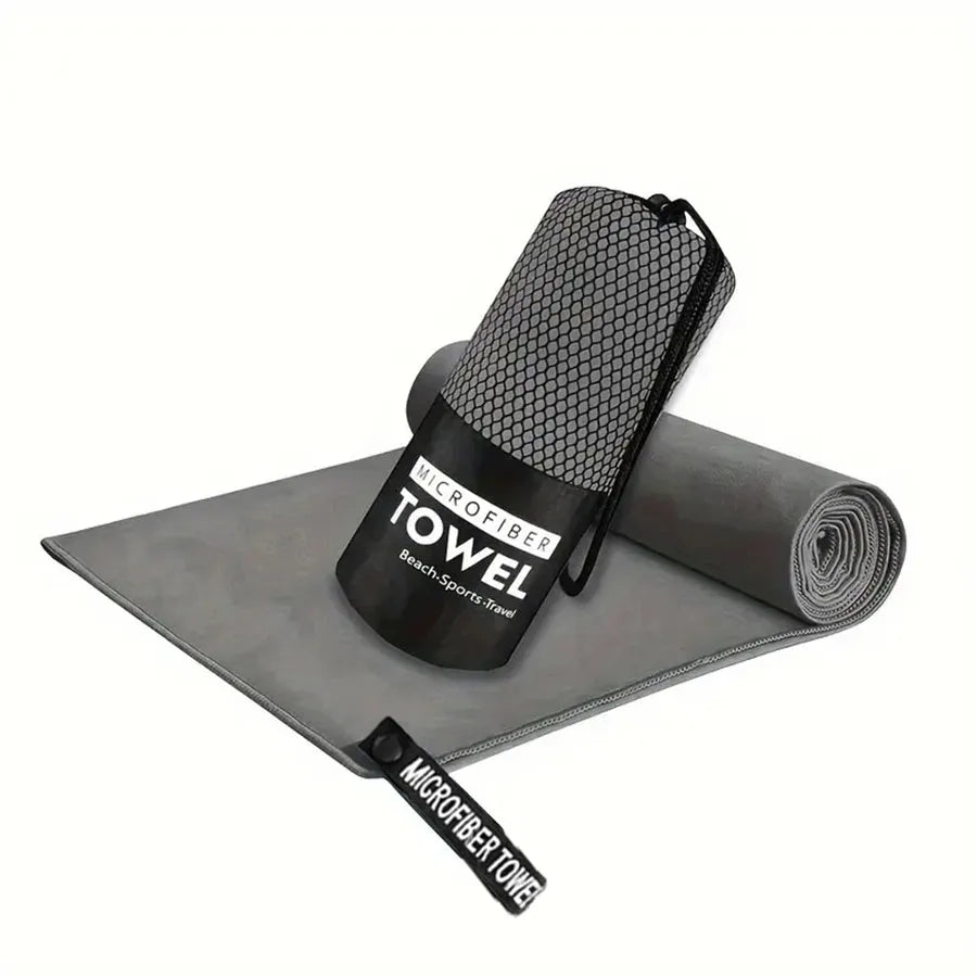 Microfiber yoga gym towel in dark gray, folded with rolled matching towel