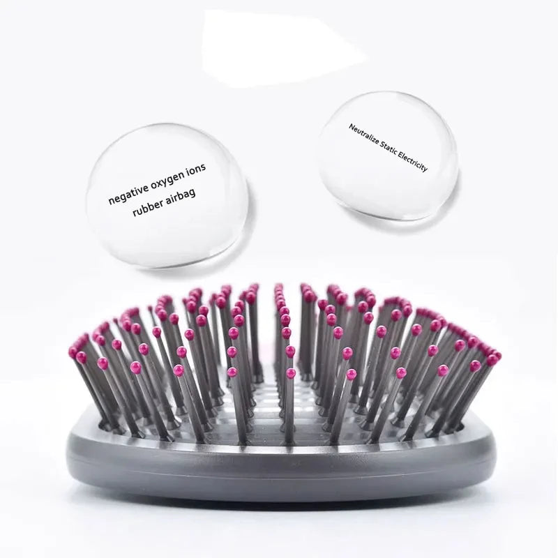 Round scalp massage hair brush head with pink-tipped pins on black base