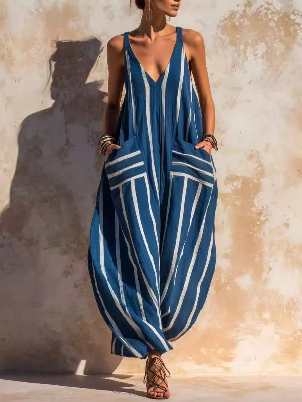 Dusty blue striped V-neck sleeveless wide-leg jumpsuit with draped pocket detail