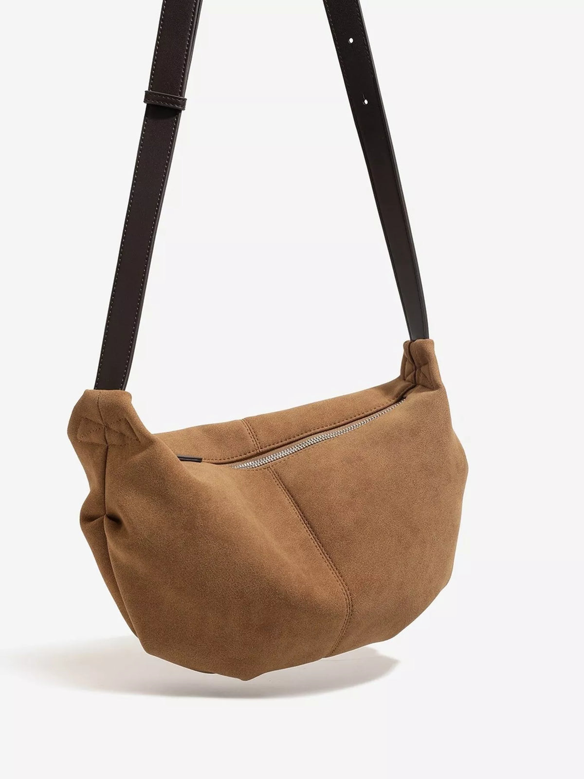 Brown suede crescent shoulder bag with center zipper seam and hanging strap