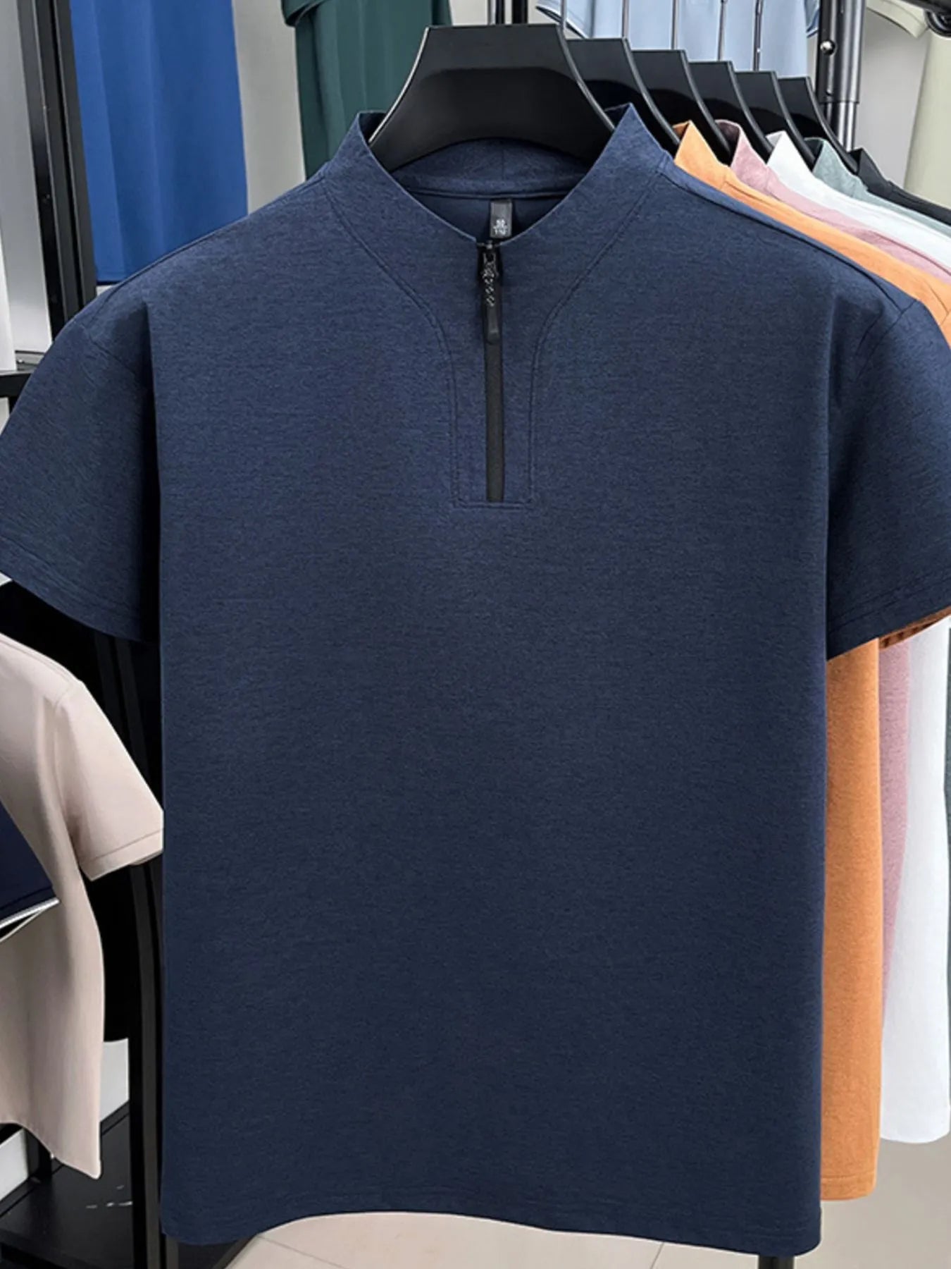 Navy quarter-zip short-sleeve top with stand collar and front zipper