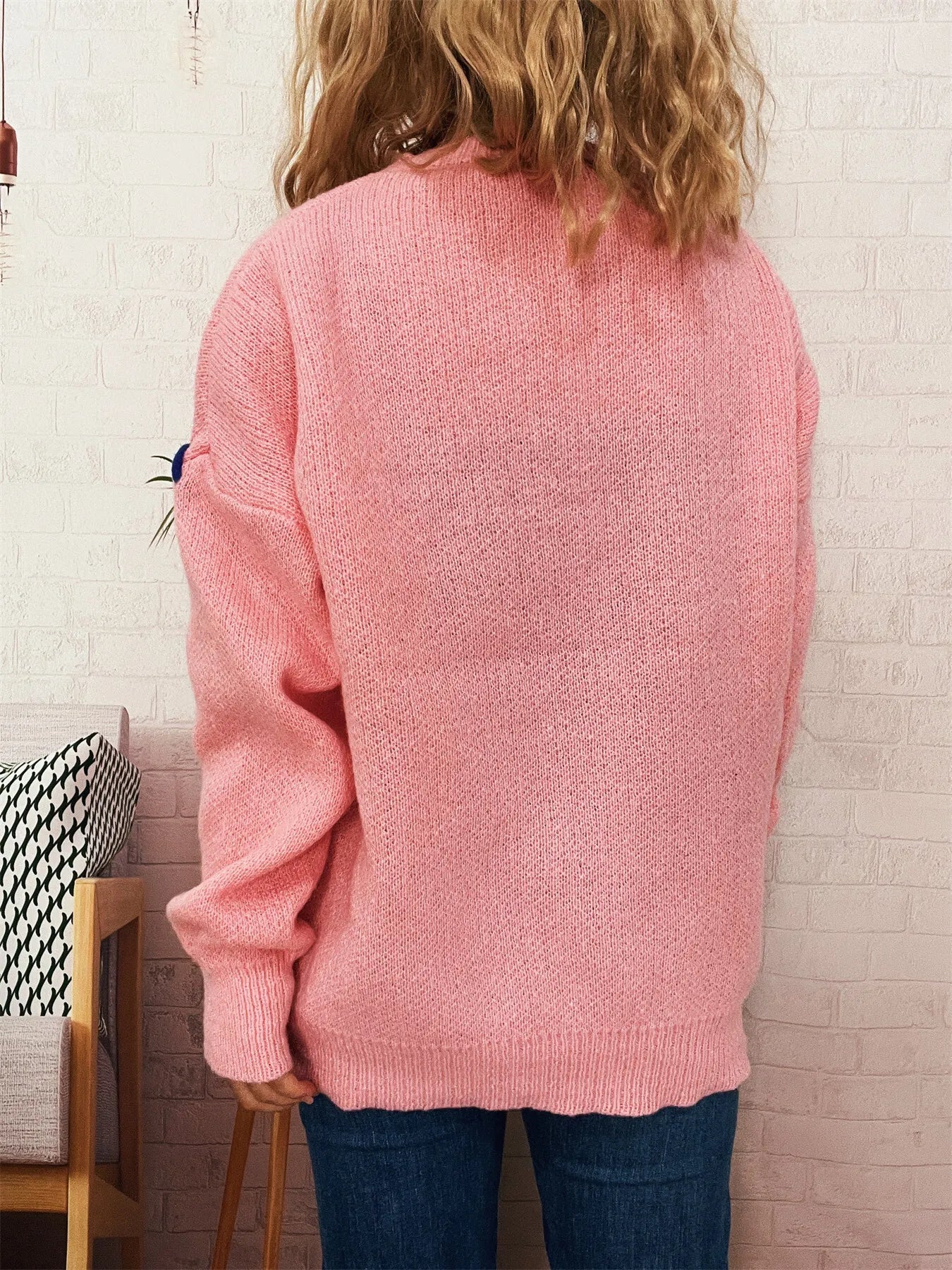 Pink round-neck knit sweater with ribbed hem and cuffs, plain back view