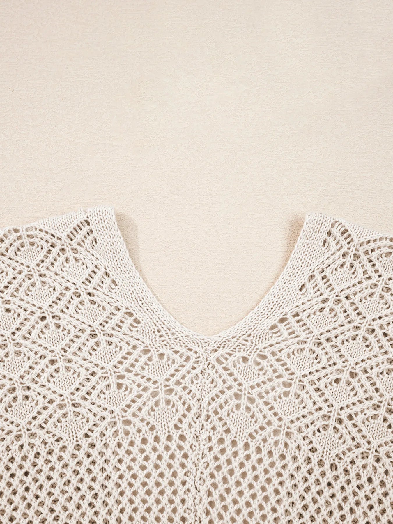 Beige hollow-knit V-neck cardigan with scalloped openwork stitch pattern