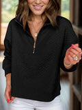 Black textured half-zip long sleeve sweatshirt with gold zipper and collar