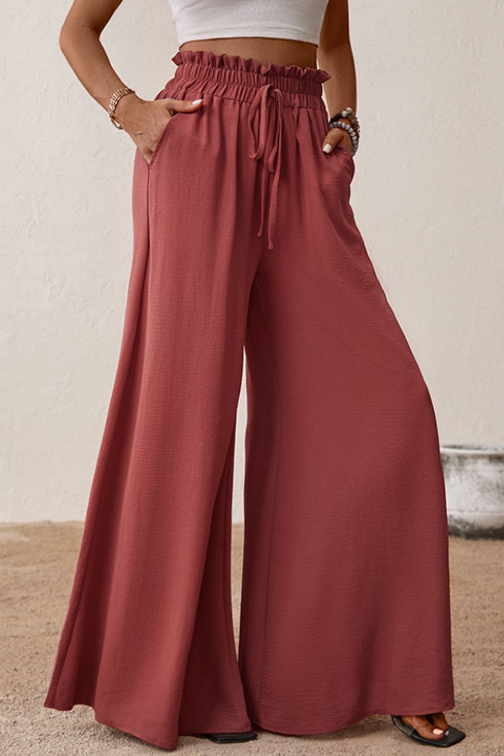 Deep red paperbag waist wide-leg pants with smocked waistband and tie details