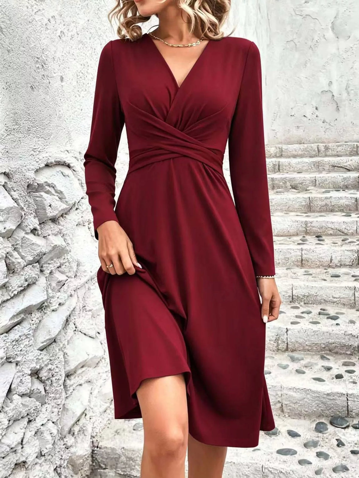 Burgundy long-sleeve midi dress with ruched crossover front and elastic waist.