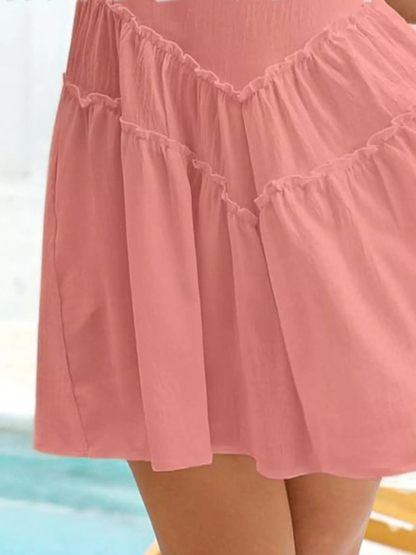 Round neck sleeveless mini dress in pink with frill detailing and pockets