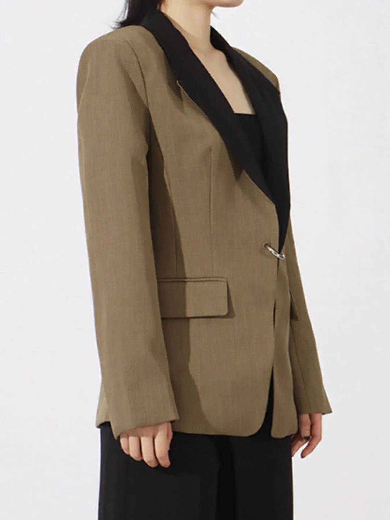 Khaki green blazer side view with black contrast lapels and flap pocket detail