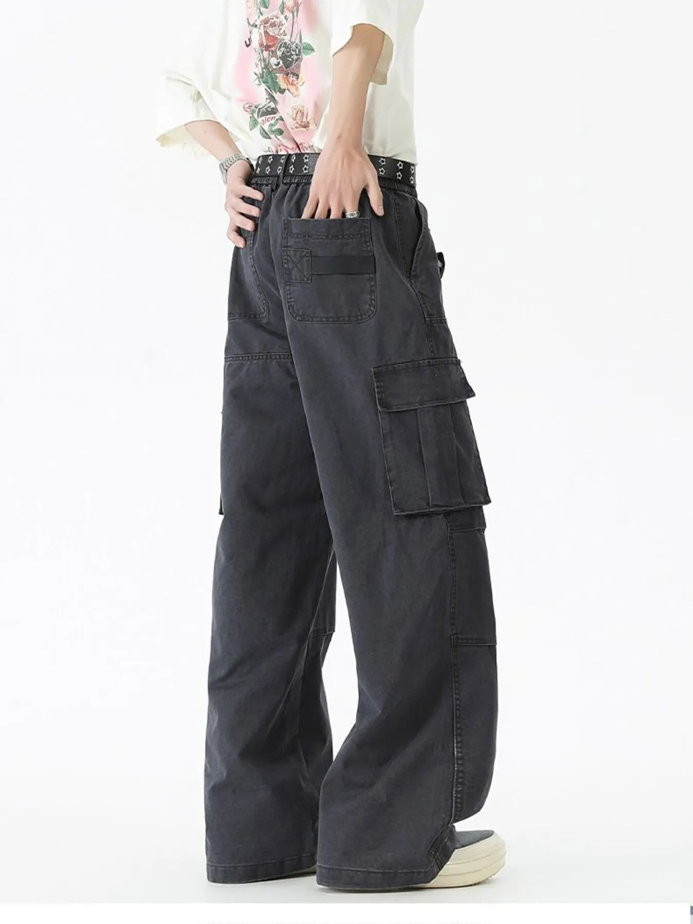Black wide-leg cargo pants with large front pockets, loose fit, and belt