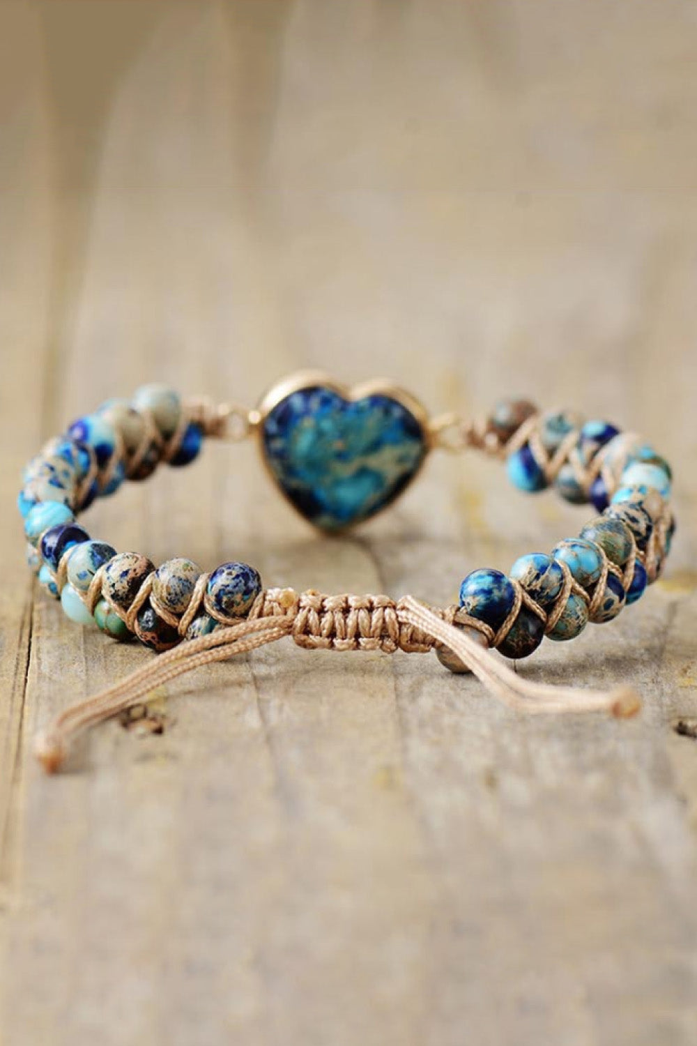 Blue and turquoise beaded heart bracelet with dark blue heart pendant and cord ties
