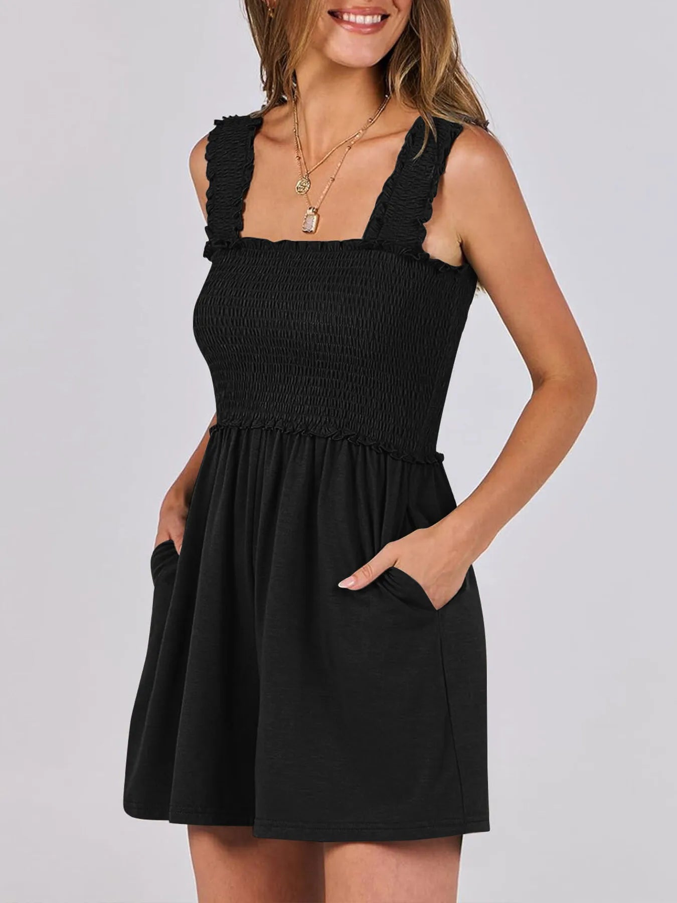 Black smocked square-neck sleeveless romper with ruffled straps and flared skirt