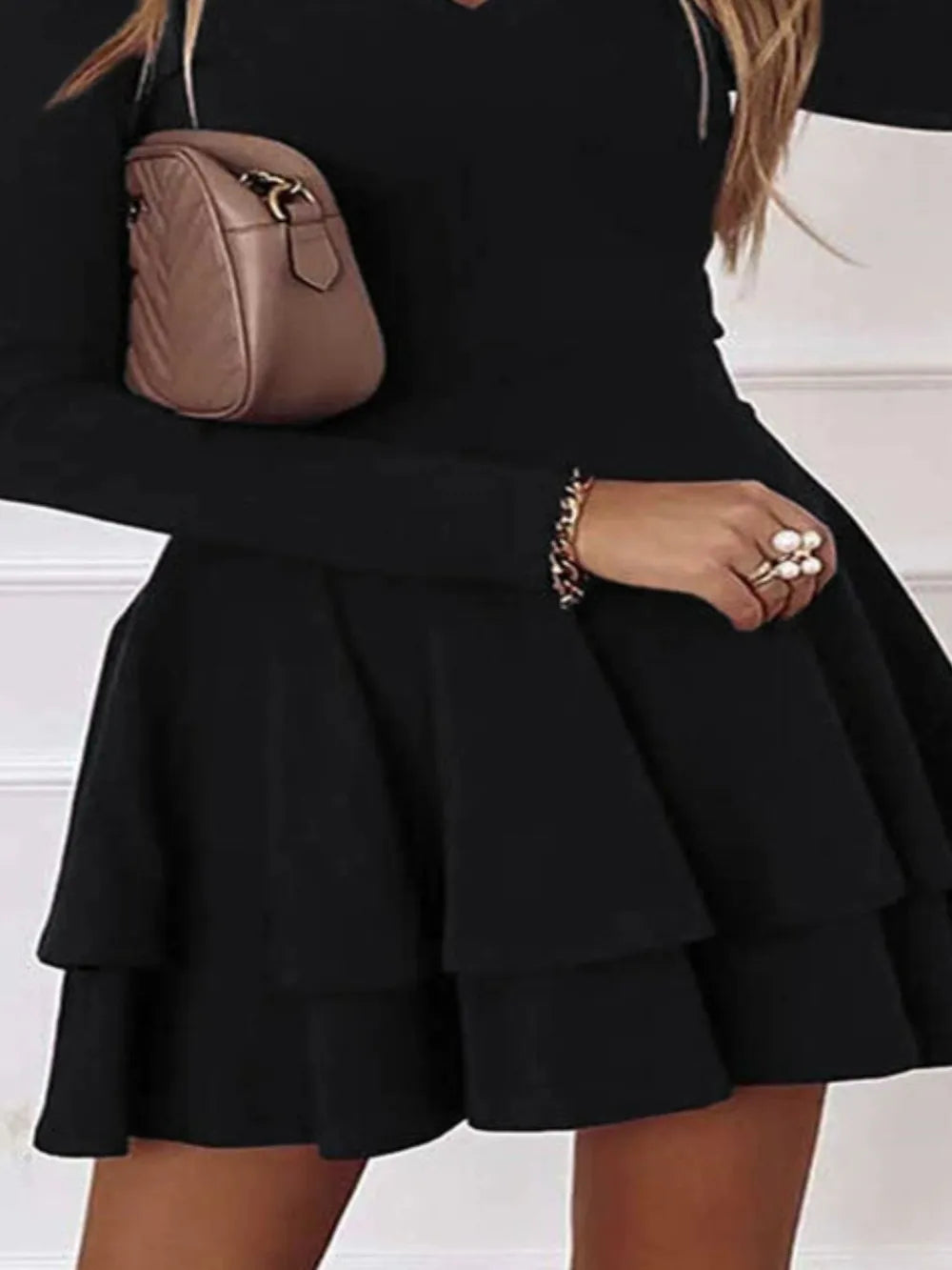 Plus Size Layered V-Neck Long Sleeve Mini Dress in black with tiered ruffle hem by Trendsi.