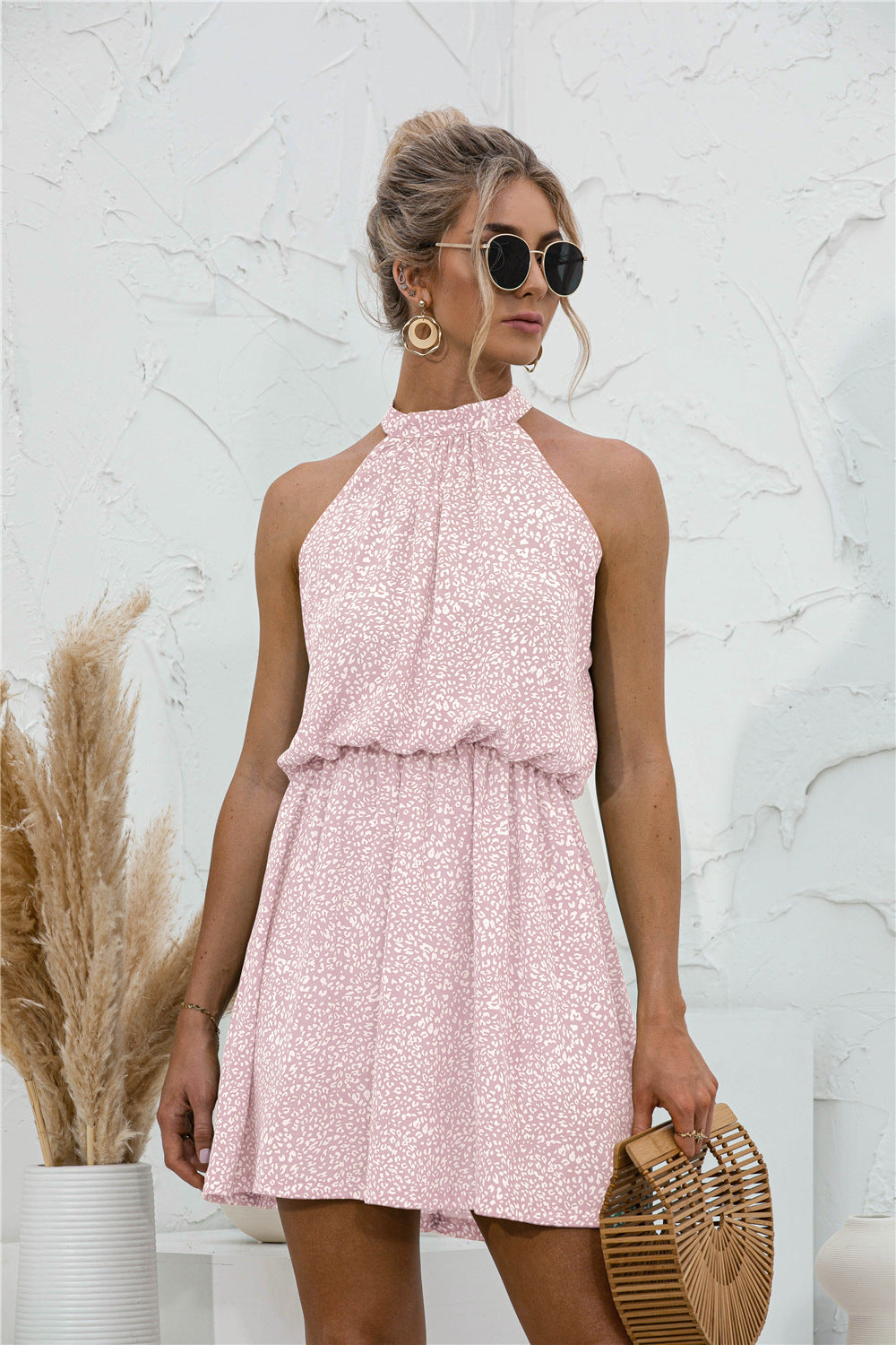 Blush pink textured mini dress with halter neckline and gathered swing skirt