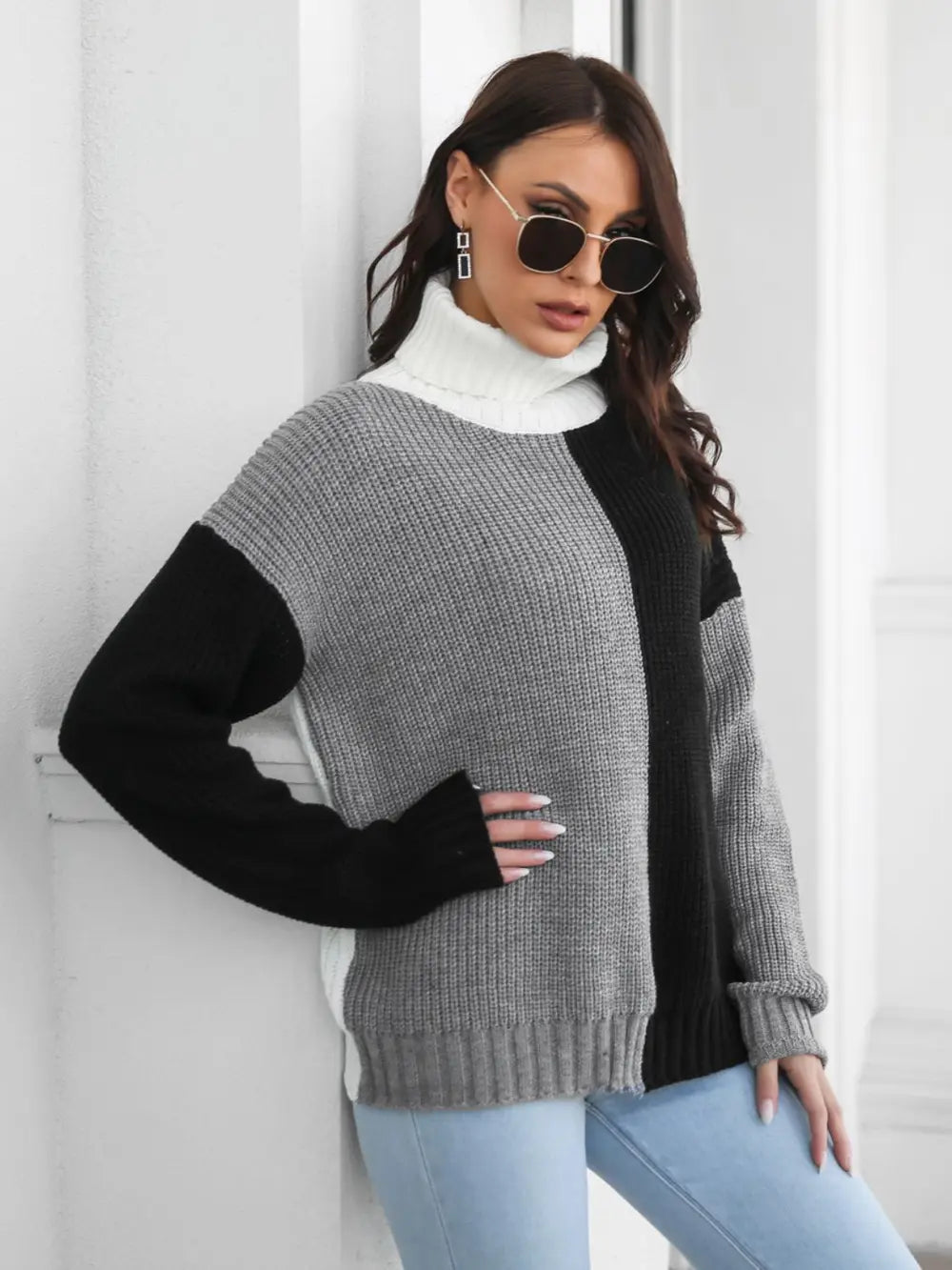 Color-block turtleneck sweater, long sleeves, ribbed cuffs, gray center with black shoulder panels.
