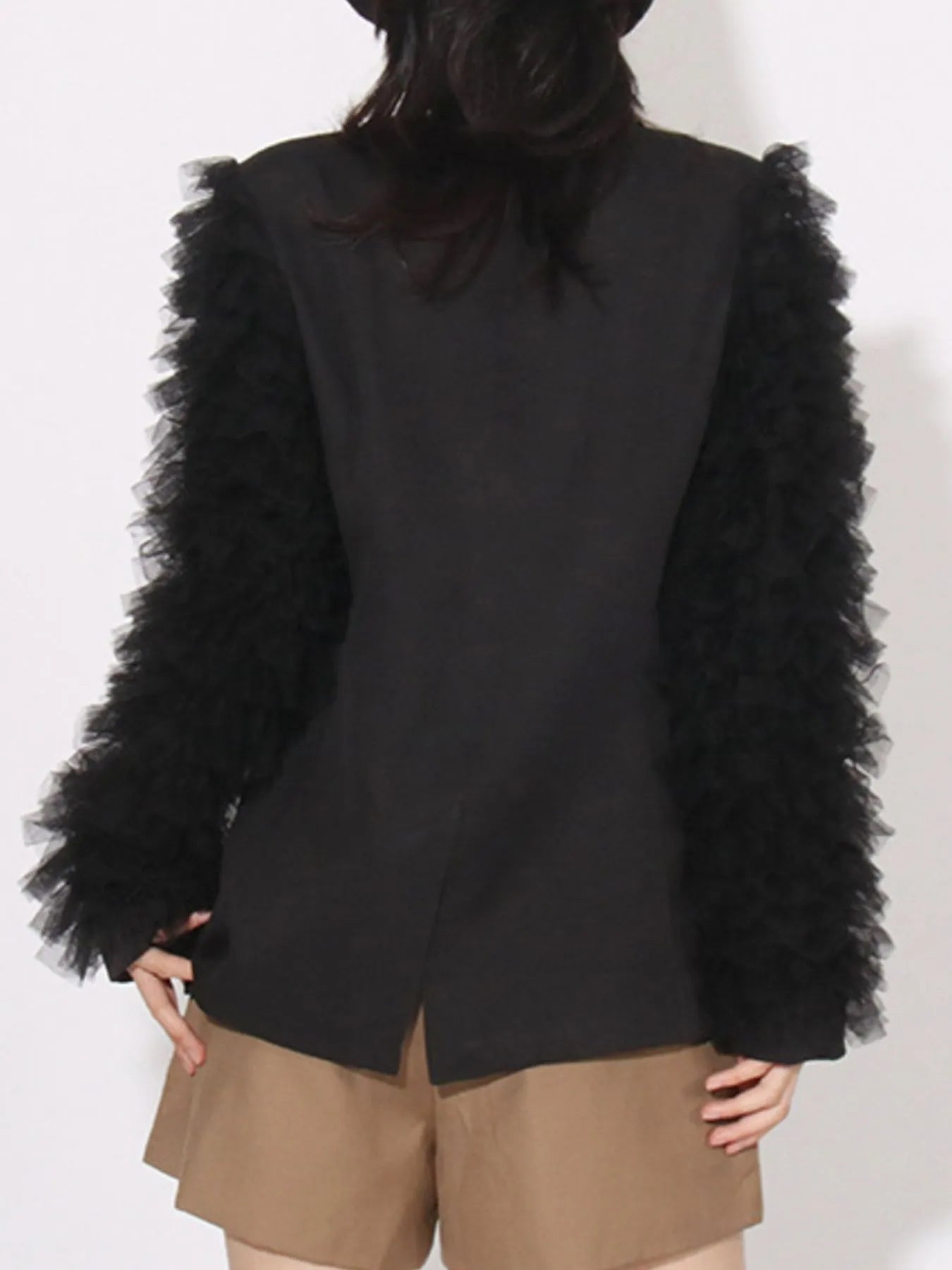 Black blazer back view with long sleeves and fluffy tulle sleeve trim