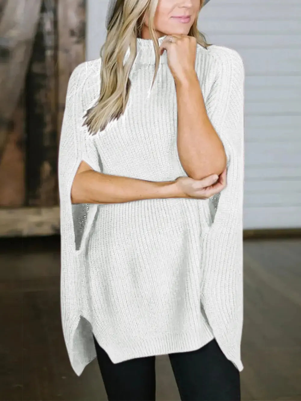 White turtleneck slit sweater with high collar, relaxed fit, and side hem split.