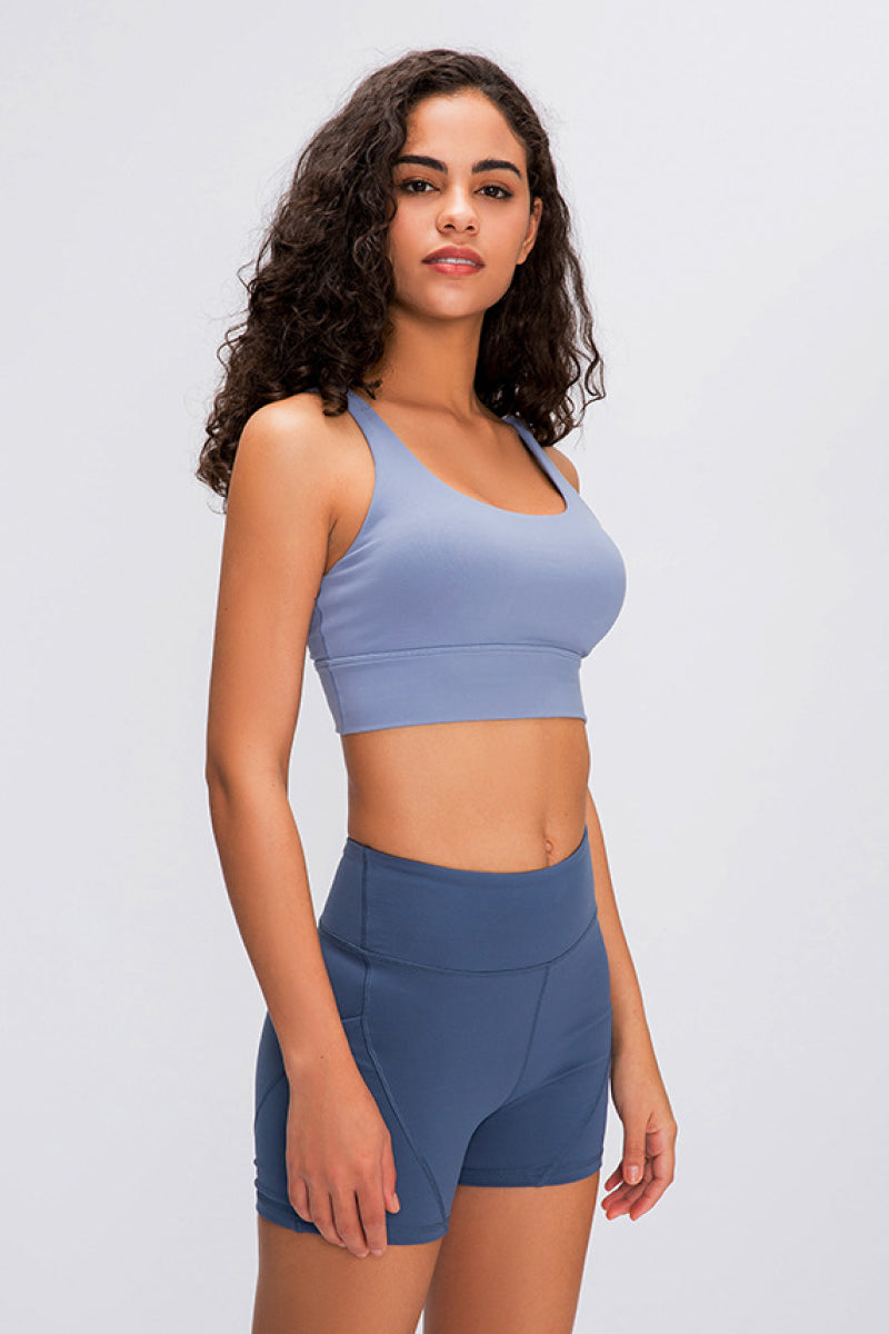 Light blue sports bra with scoop neckline and wide shoulder straps