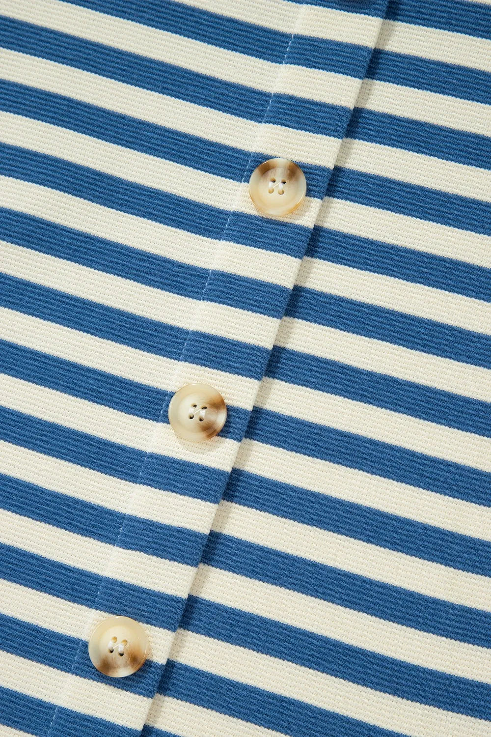 Striped button placket with round wood-tone buttons