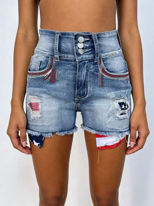 Blue distressed denim shorts with flag patches, frayed hem, front button closure